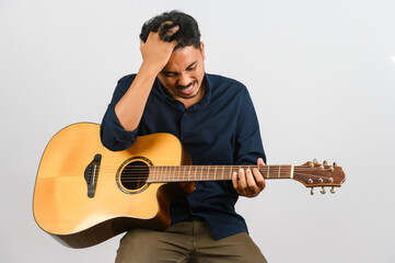 Portrait of Young Asian man playing an acoustic guitar isolated on white background