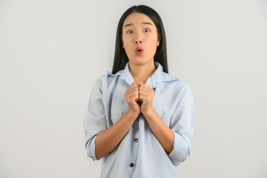 Portrait Of Young Asian Woman In Blue Shirt Looking At Camera And Exciting Isolated On White Background