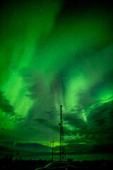 Northern Lights with antenna tower and suv