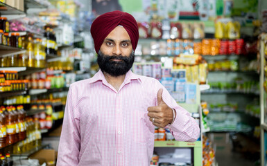 portrait of  Sikh male in grocery store with thumbs up