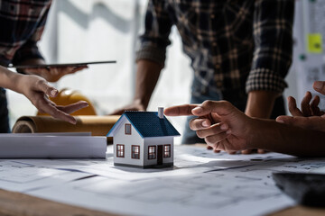 Architect team working with blueprints for architectural plan, engineer sketching a construction...