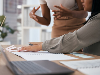 Hands, planning and sticky notes with documents on a desk in an office with a business team at work together. Discussion, meeting and strategy with female colleagues working in collaboration indoors