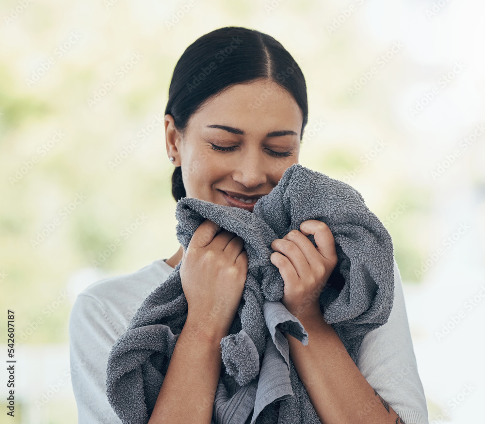 Poster Laundry, fresh and woman smelling clean clothes with a smile, peace and calm in a house. Happy, young and smiling cleaner cleaning clothing, linen and towel in the morning with happiness in a home