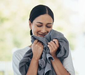 Laundry, fresh and woman smelling clean clothes with a smile, peace and calm in a house. Happy,...