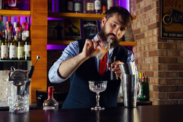 Bartender serve cocktail drink for customer at the bar