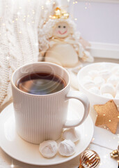 Obraz na płótnie Canvas Winter, Christmas, New Year decorations composition, concept, background. White Mug, cup of hot tea, coffee, meringue, knitted plaid. Christmas lights. Christmas mood morning. Christmas greeting card.
