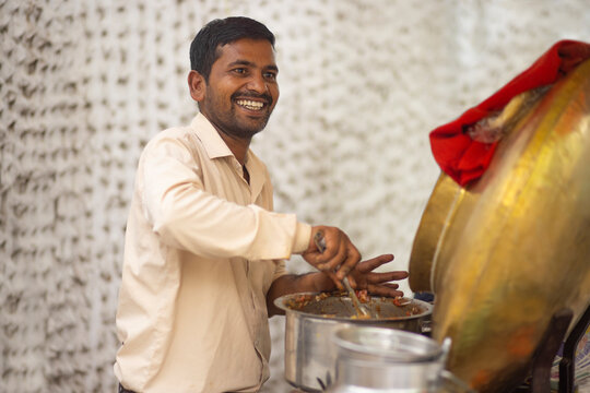 Portrait of a smiling male vendor at his roadside food stall