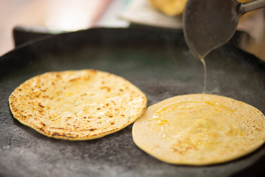 Closeup portrait of paratha preparing with ghee