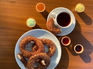 Fresh amazing simit and black tea. Traditional turkey breakfast food. Beautiful appetites bakery background. Wooden table.