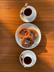 Fresh amazing simit and black tea. Traditional turkey breakfast food. Beautiful appetites bakery background. Wooden table.