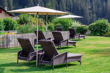 Fototapeta premium Garden with sunbeds and umbrella