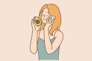 Smiling woman touch skin hold avocado in hands 