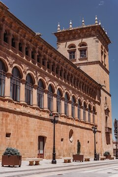 Vertical shot of the Palace of Los Condes de Gomara in front of a blue sky, Soria, Spain