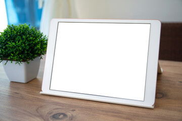 white computer tablet with isolated screen on table in cafe