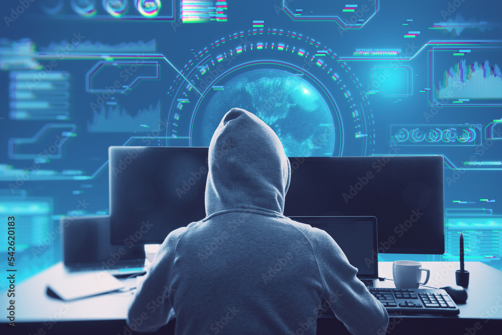 Aufkleber hacker in hoodie sitting at desktop with coffee cup and using computer monitors with abstract glowing digital business interface with globe and various other icons on blurry blue background. 