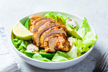 Grilled chicken breast salad with avocado and caesar dressing. Keto diet food.