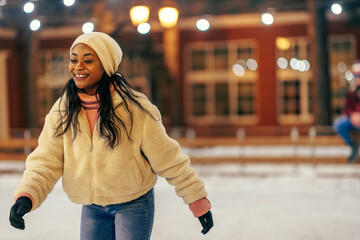 African woman ice skating outdoors