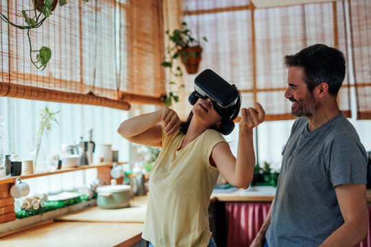 Couple playing with virtual reality headsets - Powered by Adobe