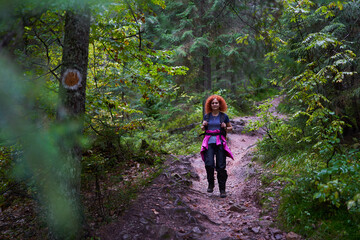 Woman hiker with backpack in the forest