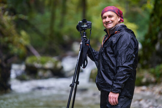 Nature photographer shooting landscapes in a canyon with a river