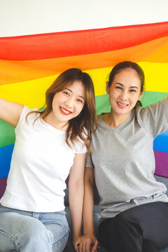 Portrait of happy smile southeast asian woman lgbt couple with rainbow pride flag