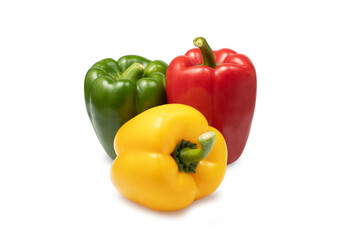 a group of three colored sweet peppers on a white