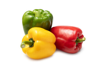 a group of three colored sweet peppers on a white