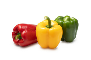 a group of three colored sweet peppers on a white