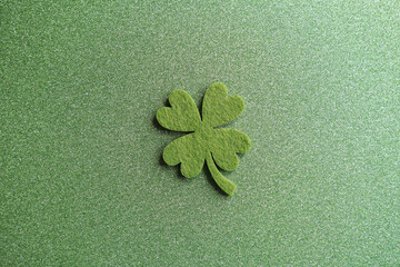 four-leaf clover made from felt on green sparkling background