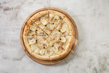 Sweet pizza with pear, brie cheese on the concrete background