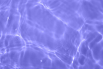 Defocus blurred transparent purple colored clear calm water surface texture with splash, bubble....