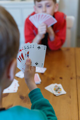 Two school boys playing cards