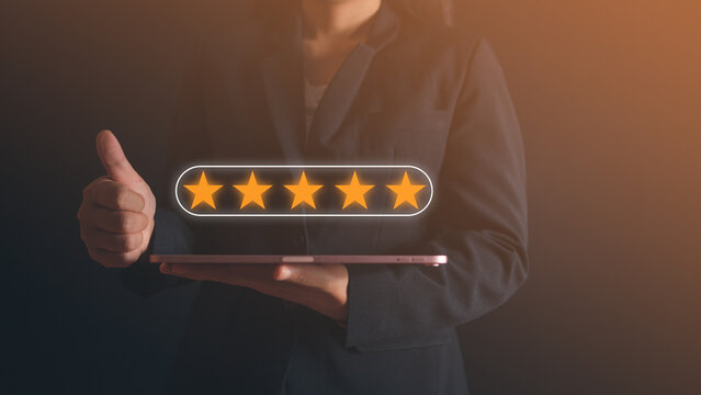 businesswoman holding tablet and giving thumb up with customer service and satisfaction concept, Business people showing the virtual screen on the happy Smiley face icon to give satisfaction. - Powered by Adobe