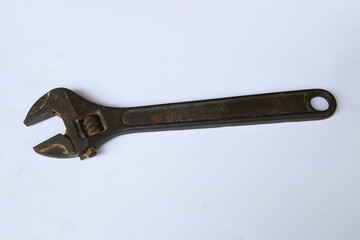 Old rusty adjustable wrench on white background. Old rusty iron wrench with clipping path. Top-view