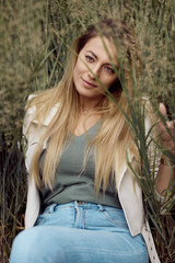 A beautiful woman posing in grass.