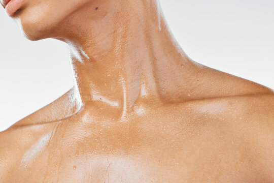 Skincare, neck and man in studio for beauty, wellness and hydration closeup against a white background. Fitness, exercise and throat skin care by model, sweat and cosmetic, moisture and serum product
