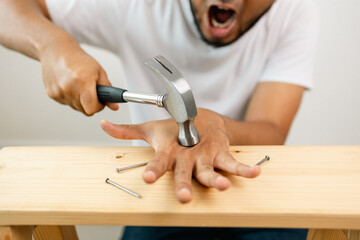 The carpenter was injured by hammer and nails. He misused the hammer and stuck it in his hand....