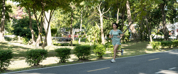 Asian woman runners. She was running on the park in the morning. banner panoramic.