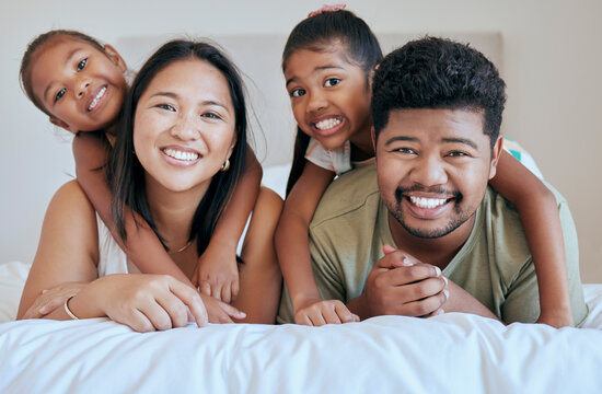 Happy Family, Bed And Girl With Mother, Father And Sister In A Bedroom For Fun, Bond And Rest Together. Face, Portrait And Mexican Family Hug, Smile And Happy With Kids And Parents Embrace In Mexico