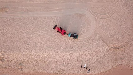 Aerial shot of beach tracktor cleaning manly beach