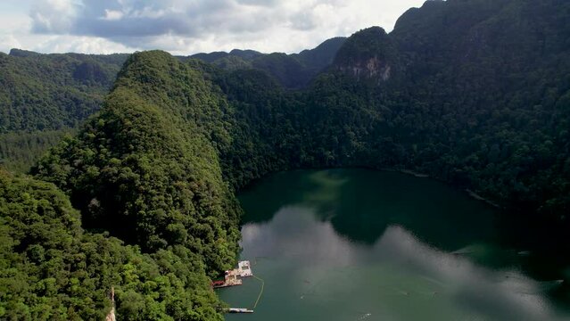 Tranquil Lake Is Surrounded By Mountains With Lush Forest In Dayang Bunting Island, Langkawi, Malaysia. Aerial Pullback Shot