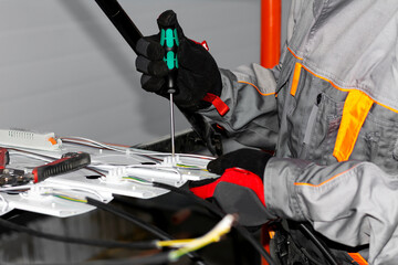 The installer connects an electric LED lamp. Installation of indoor lighting	