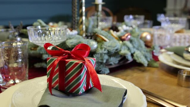 Table setting close-up on Christmas Eve and gifts for family members on plates