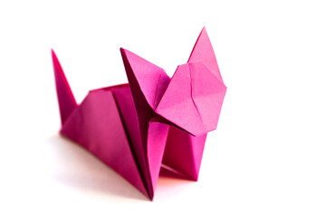Pink paper cat origami isolated on a white background