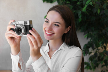 Young woman taking picture at cafe. Creative hobby