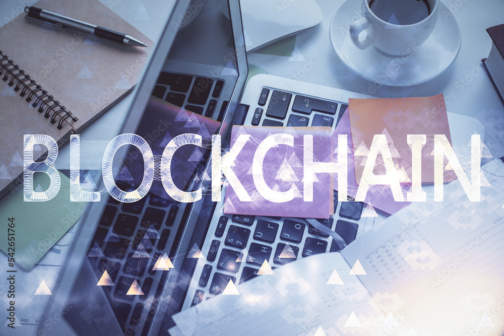Poster blockchain theme hologram drawings over computer on the desktop background. top view. multi exposure