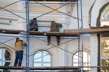 Novomoskovsk, Russia - October 25, 2022: worker plastering a wall