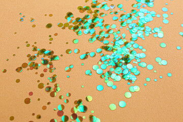 Shiny bright glitter scattered on beige background