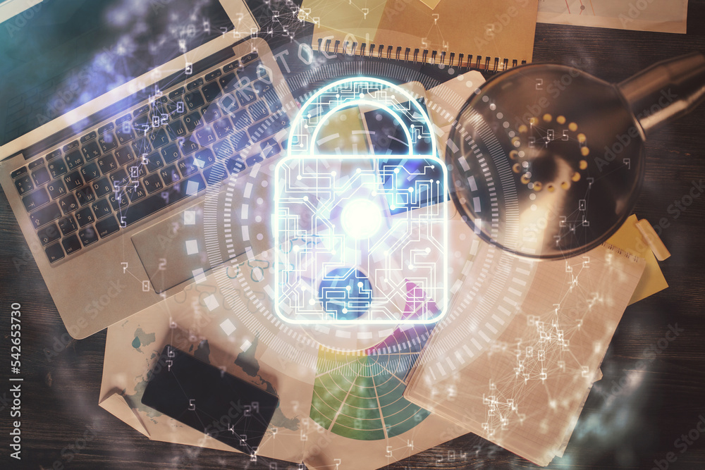 Poster Double exposure of lock hologram drawing over study table background with computer. Concept of data security. Top view.