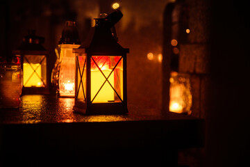 Obraz na płótnie Canvas Votive candle burning at a cemetery at night